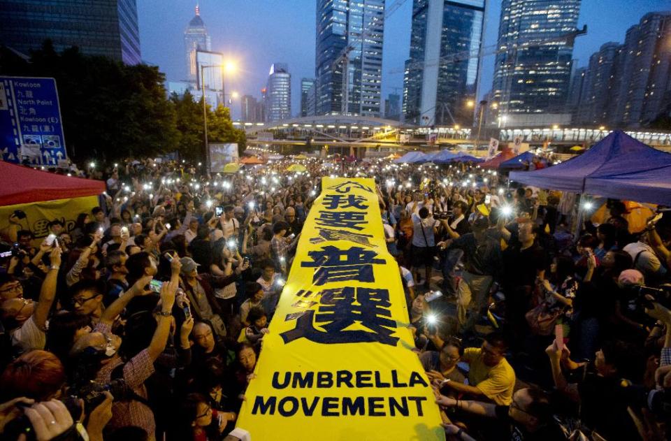 In this Tuesday, Oct. 28, 2014 photo, pro-democracy protesters spread a yellow banner with the words reading: &quot;I want genuine universal suffrage&quot; at a rally in the occupied areas outside government headquarters in Hong Kong&#39;s Admiralty. Pro-democracy protests in Hong Kong stretched into a fourth week, as student leaders pushing for a greater say in choosing the territory&#39;s chief executive met with government officials but agreed on little. (AP Photo/Kin Cheung)