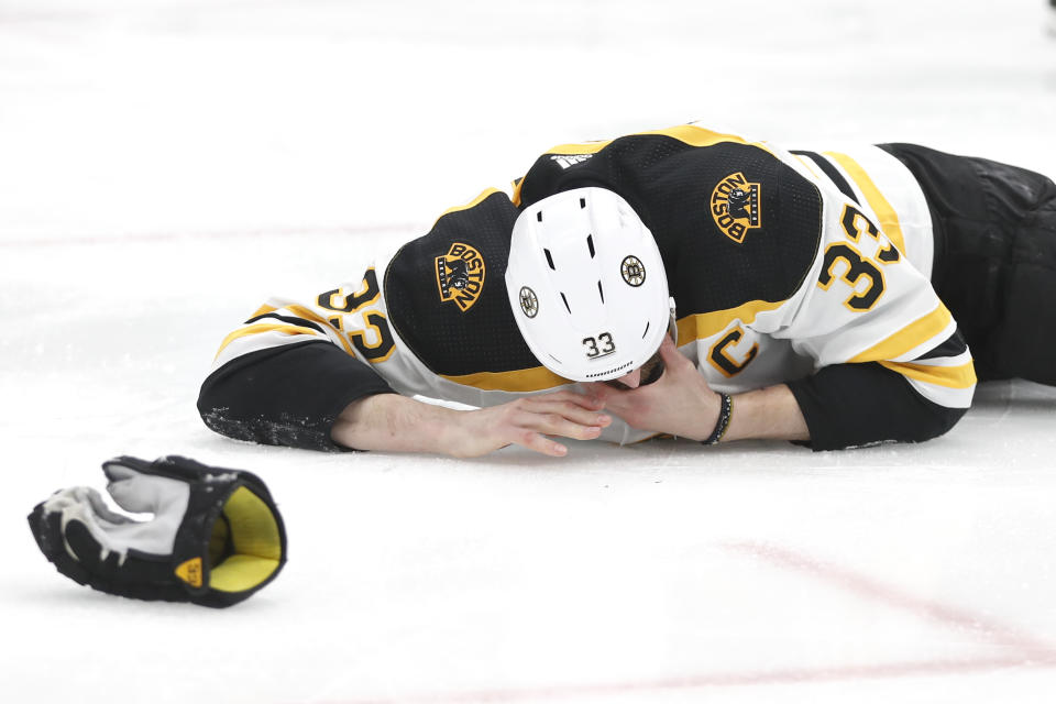 Boston Bruins defenseman Zdeno Chara, of Slovakia, lies on the ice after getting hit in the face with the puck during the second period of Game 4 of the NHL hockey Stanley Cup Final against the St. Louis Blues Monday, June 3, 2019, in St. Louis. (AP Photo/Jeff Roberson)