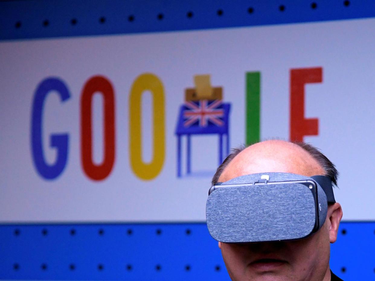 A visitor tries a pair of VR glasses with a smartphone at the Google digital workshop stand at the Labour party Conference in Brighton, Britain, September 24, 2017: REUTERS/Toby Melville
