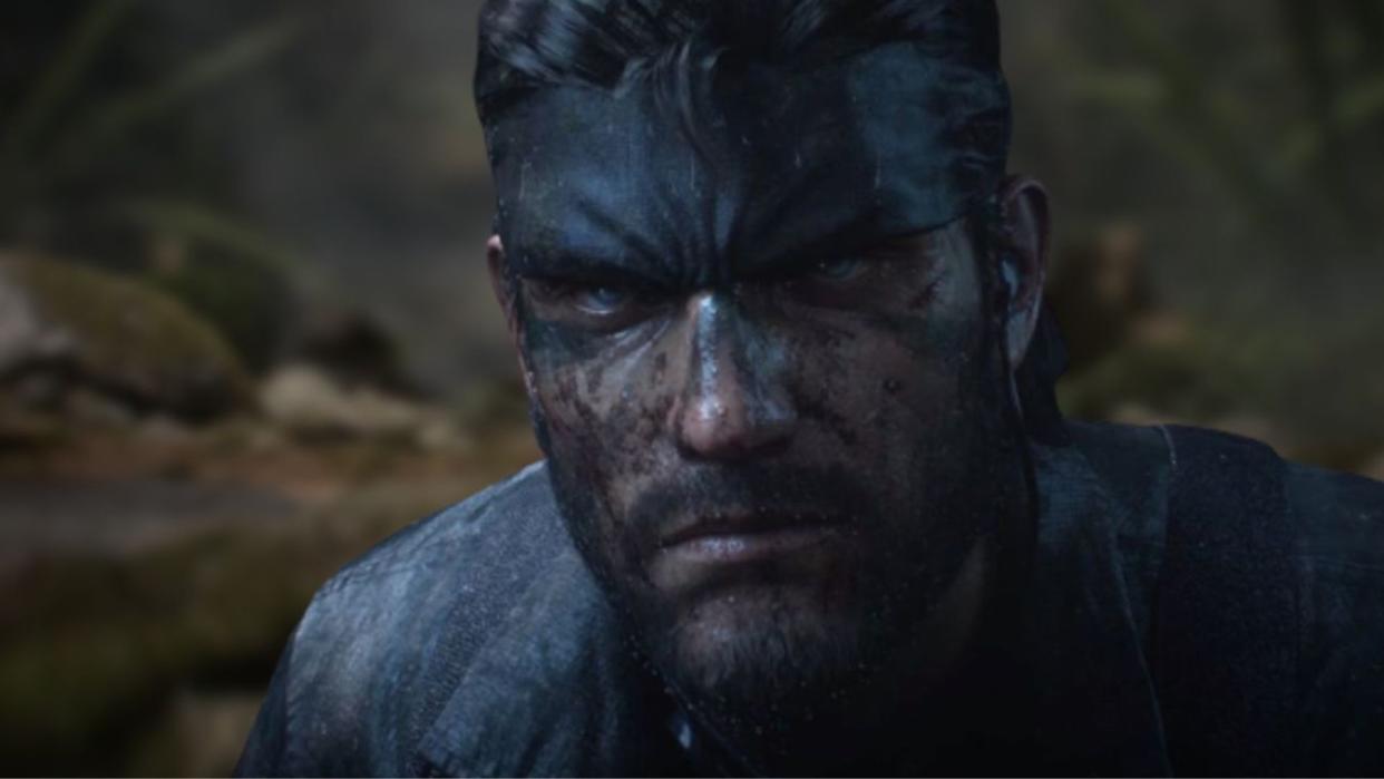  A close up of Snake in Metal Gear Solid 3 Snake Eater remake. His face is covered in mud. 