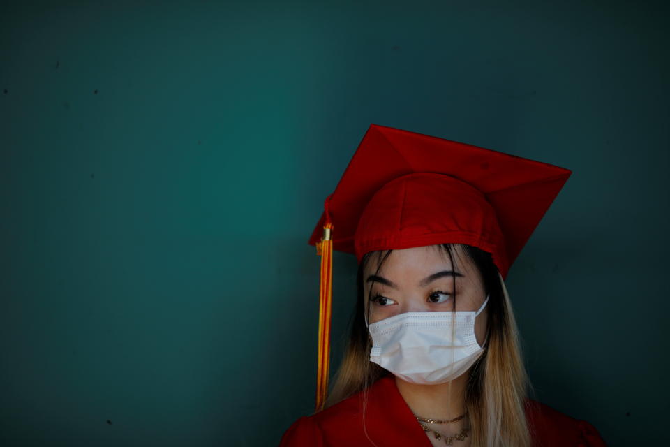 High school senior Angie Wu waits before the Josiah Quincy Upper School's graduation ceremonies at Fenway Park in Boston, June 8, 2021. REUTERS/Brian Snyder