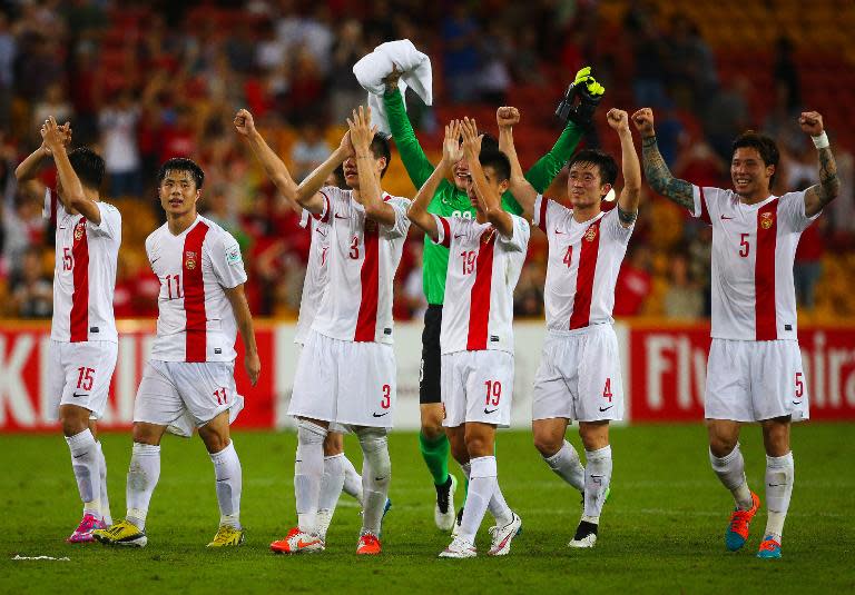 The Chinese team salutes fans following their Asian Cup match against Uzbekistan in Brisbane on January 14, 2015