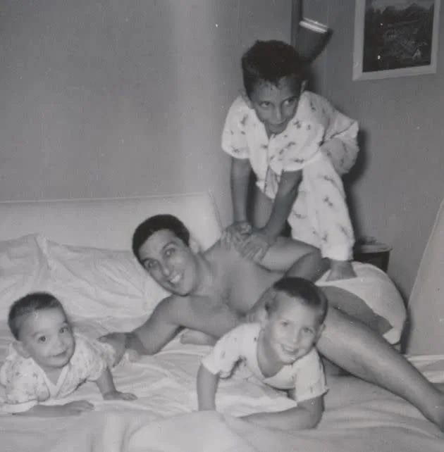 A 1959 photo shows Eugene Glick with his sons, Steve (left), Daniel (center) and Bob (on top of Eugene), who died in 2001. (Photo: Courtesy of The Glick Family)