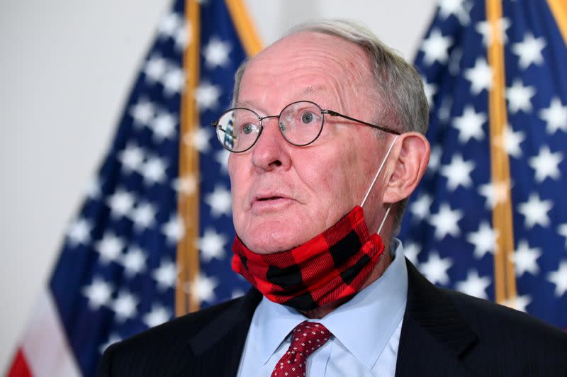 U.S. Senator Alexander speaks to reporters before a luncheon on Capitol Hill in Washington