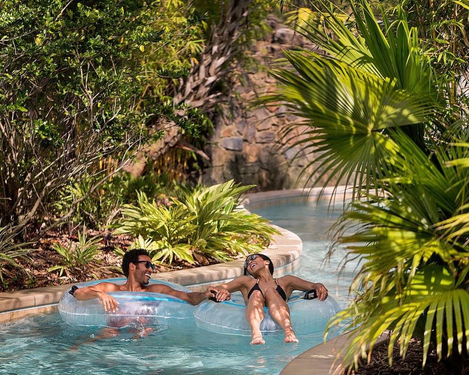 The Explorer Island water park at Four Seasons Resort Orlando is set among tropical foliage and cascading waterfalls for the ultimate in relaxation.