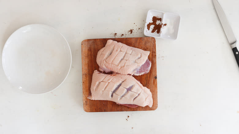 raw duck breast seasoned with salt 