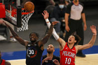 New York Knicks forward Julius Randle (30) and New Orleans Pelicans center Jaxson Hayes (10) battle for a rebound during the first half of an NBA basketball game Sunday, April 18, 2021, in New York. (AP Photo/Adam Hunger, Pool)