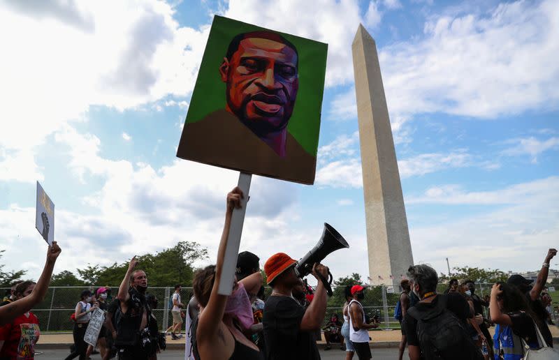 Demonstrators take part in "Get Your Knee Off Our Necks" march in Washington