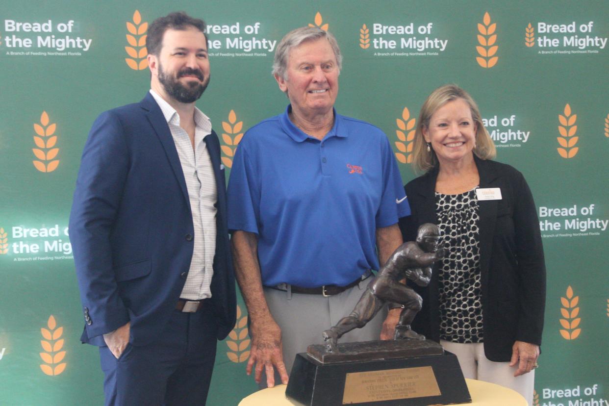 Patrick Dodds, left, the executive director of Bread of the Mighty, stands with former University of Football head coach and quarterback Steve Spurrier, center, and Susan King, the CEO of Feeding Northeast Florida, during the 2023 Empty Bowls luncheon fundraiser.