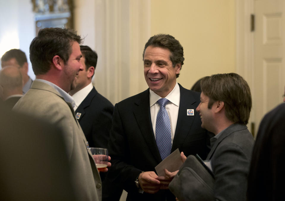 New York Gov. Andrew Cuomo, left, talks to visitors to the Executive Mansion as part of a "Wine, Beer and Spirits Summit" on Wednesday, Oct. 24, 2012, in Albany, N.Y. The aim of the summit is to boost wine production and craft brewers, in part to spur job growth. Visitors to the mansion were able to sample products from around New York state. (AP Photo/Mike Groll)