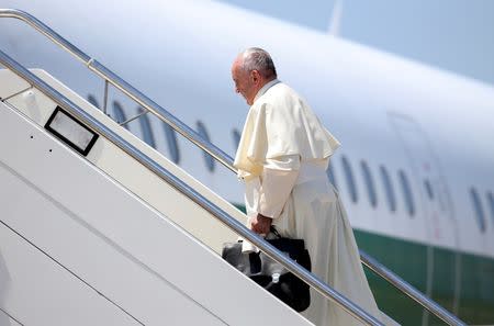 Pope Francis boards a plane at Fiumicino Airport in Rome, Italy July 27, 2016. REUTERS/Alessandro Bianchi