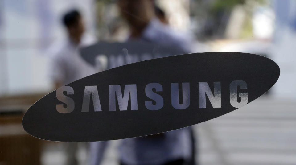 People walk by the entrance to the Samsung Electronics Co. showroom at its headquarters in Seoul, South Korea, Friday, Aug. 31, 2012. The Tokyo District Court on Friday dismissed Apple Inc.'s claim that Samsung had infringed on its patent - the latest ruling in the global legal battle over smartphones that pits the two technology titans against each other. (AP Photo/Lee Jin-man)