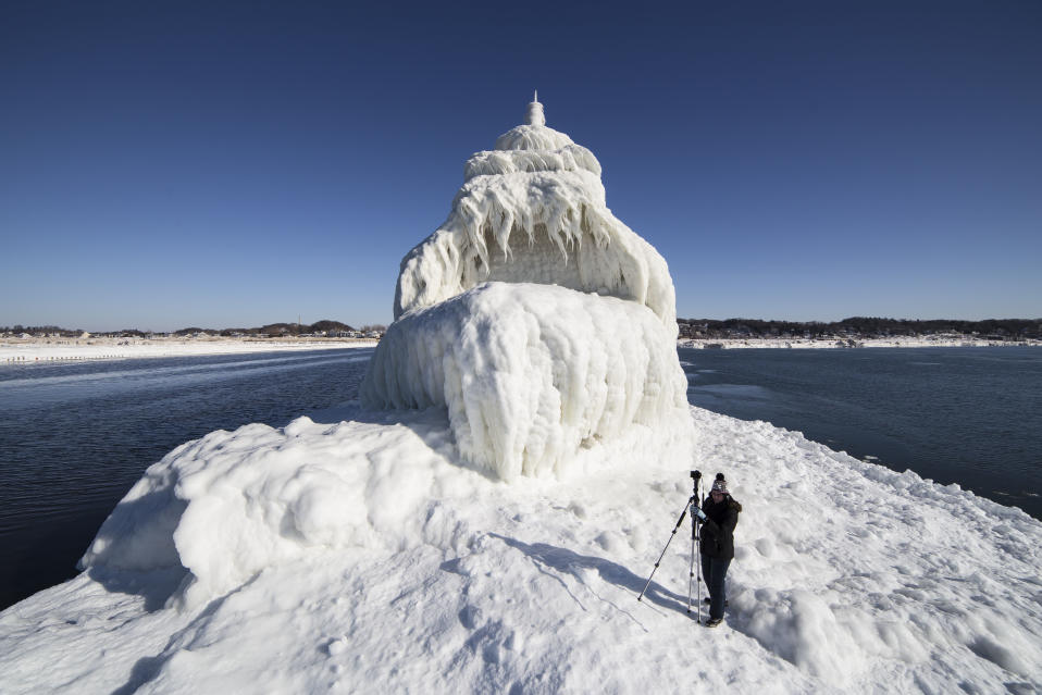 SOUTH HAVEN, MI - JANUARY 13: Grand Haven South Pier Entrance Light is covered with ice and snow, on January 13, 2015, in South Haven, Michigan.ICE engulfs a red lighthouse as a fierce winter storm grips South Haven, Michigan. Sharp icicles and surreal formations can be seen hanging from the railings after strong waves crashed onto the piers. After each coating the water quickly freezes to ice and the pier is transformed into a slippery, white wonderland. Weather in the area dipped into the minus figures and froze over Lake Michigan in the beginning of January.PHOTOGRAPH BY Mike Kline / Barcroft MediaUK Office, London.T +44 845 370 2233W www.barcroftmedia.comUSA Office, New York City.T +1 212 796 2458W www.barcroftusa.comIndian Office, Delhi.T +91 11 4053 2429W www.barcroftindia.com