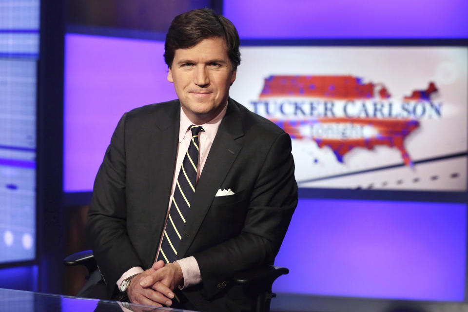 FILE - Tucker Carlson, host of "Tucker Carlson Tonight," poses for photos in a Fox News Channel studio on March 2, 2017, in New York. The Delaware judge overseeing Dominion Voting Systems' $1.6 billion defamation lawsuit against Fox News announced late Sunday, April 16, that he was delaying the start of the trial until Tuesday, April 18. The trial had been scheduled to start Monday morning with jury selection and opening statements. Fox News stars Carlson and Sean Hannity and founder Rupert Murdoch are among the people expected to testify over the next few weeks. (AP Photo/Richard Drew, File)