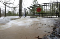This time exposure shows the strength of the Pearl River floodwaters on this residence on Florence-Byram Road near Byram, Miss., on Monday, Feb. 17, 2020. Authorities believe the flooding will rank as third highest, behind the historic floods of 1979 and 1983. (AP Photo/Rogelio V. Solis)