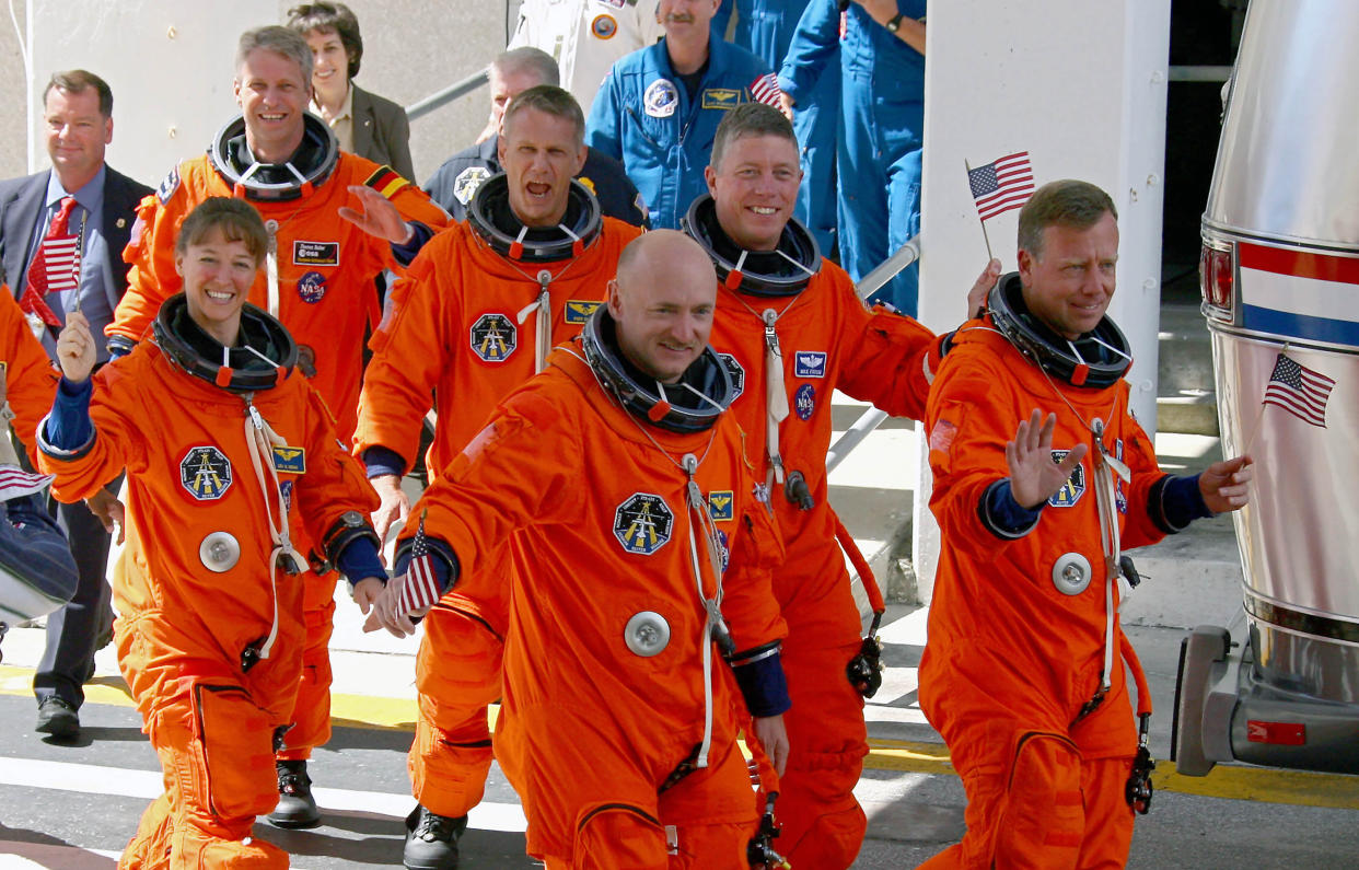 Then-astronaut Mark Kelly, center, and other members of the space shuttle Discovery crew head to the launchpad at Kennedy Space Center in Cape Canaveral, Fla., July 4, 2006. (Chang W. Lee/The New York Times)