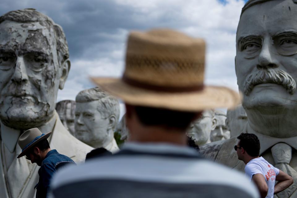 People look at the decaying remains of salvaged busts of former US Presidents during a tour by John Plashal August 25, 2019, in Williamsburg, Virginia. (Photo: Brendan Smialowski/AFP/Getty Images)
