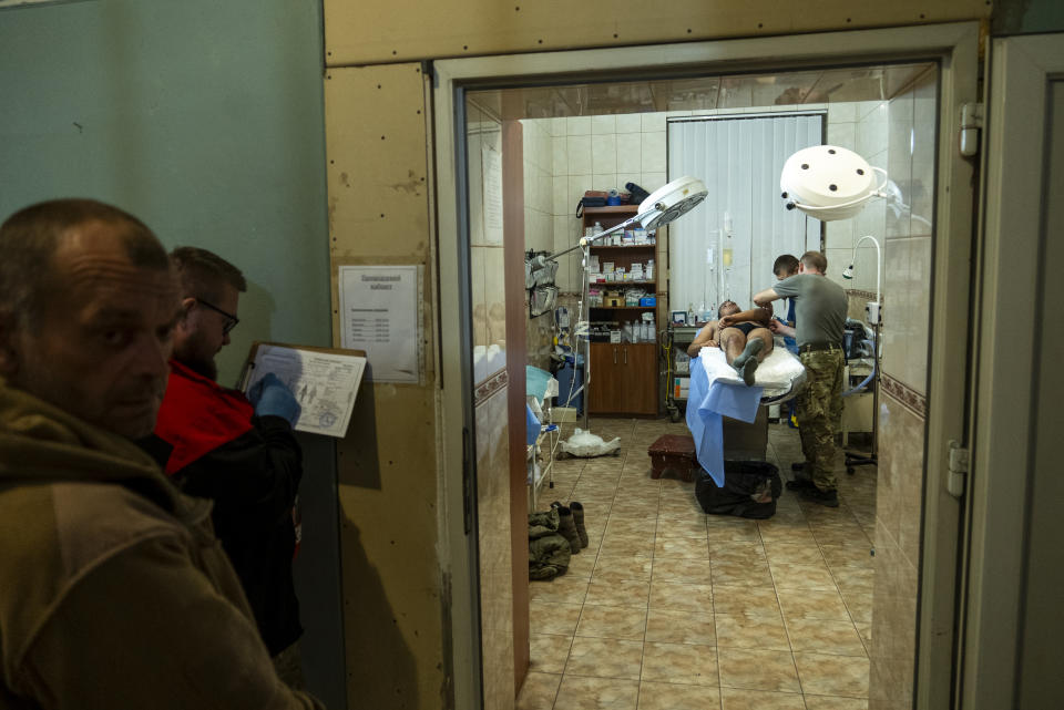 A Ukrainian serviceman receives is treated at a field hospital near Bakhmut, Donetsk region, Ukraine, Sunday, Sept. 10, 2023. When Ukrainian soldiers finally reclaimed Andriivka last week, it was at a high cost in lives. The village is significant largely because it's on the road to the Russian-held city of Bakhmut. (AP Photo/Mstyslav Chernov)