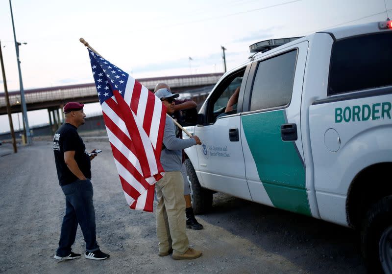 FILE PHOTO: Military veterans walk on the border between the U.S. and Mexico to request their return to the United States, in El Paso