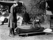 Two Red Cross nurses with a person on a stretcher during a demonstration at the Red Cross Emergency Ambulance Station during the influenza pandemic of 1918-1920, Washington DC, 1918. (Photo by Underwood Archives/Getty Images)