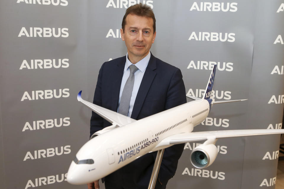 FILE - Airbus CEO Guillaume Faury poses by a replica of an Airbus A 350-900 during Airbus annual press conference in Toulouse, southwestern France, Thursday, Feb.13, 2020. The owner of Air India announced a deal Tuesday Feb.14, 2023 to buy 250 Airbus jets, including A350 wide-body planes and A320neo single-aisle planes in a deal worth billions of dollars. Air India, owned by Tata Group, is reportedly considering a similar order for Boeing as part of expansion efforts. (AP Photo/Frederic Scheiber, File)