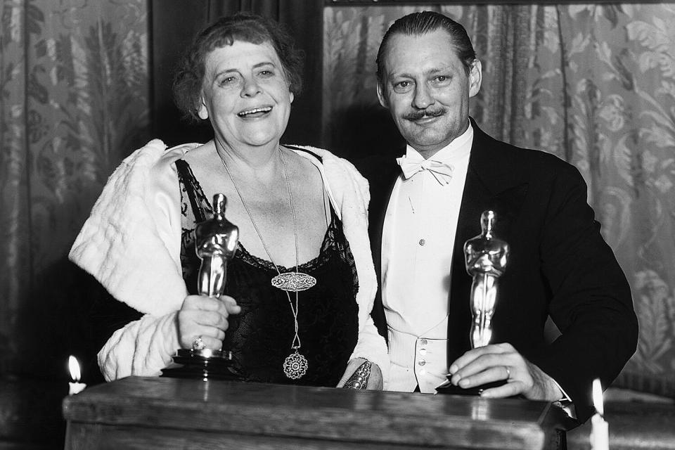 Marie Dressler holds her Oscar for Best Actress and Lionel Barrymore holds his for Best Actor during the 1931 Academy Awards Ceremony.