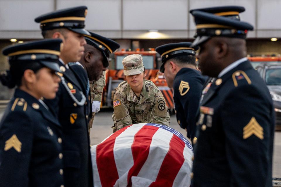 The remains of Lt. John Heffernan, a WW2 US bomber navigator who was shot down in Burma in 1944, arrive at Newark Liberty Airport on Tuesday November 15, 2022. Spc. Arca hands the flag-draped casket to the Honor Guard.