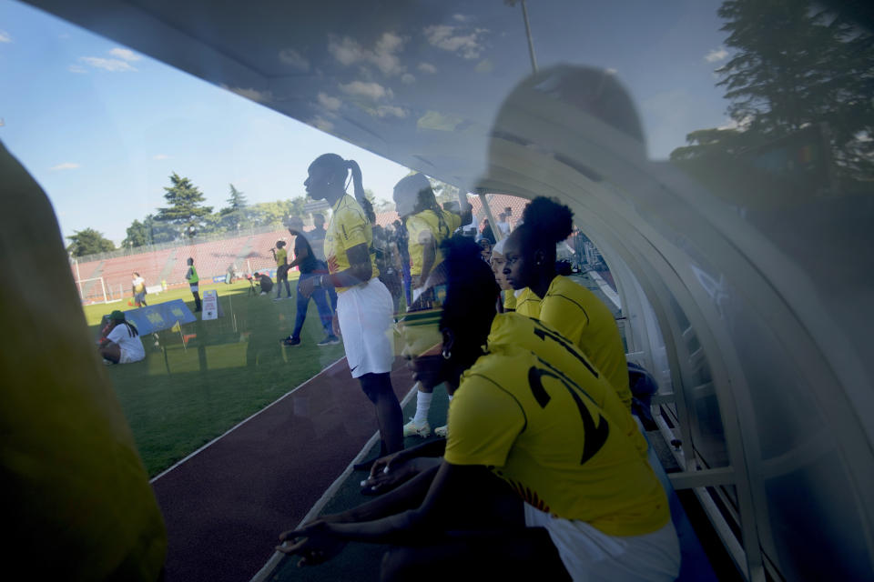 Substitutes watch the players during the women's final game of the national cup of working-class neighborhoods betwwen a team representing players with Malian heritage against one with Congolese roots, in Creteil, outside Paris, France, Saturday, July 2, 2022. This amateur tournament aims to celebrate the diversity of youth from low-income communities with high immigrant populations, areas long stigmatized by some observers and politicians as a breeding ground for crime, riots, and Islamic extremism. (AP Photo/ Christophe Ena)