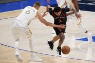 Toronto Raptors guard Jalen Harris (2) loses control of the ball as he's fouled by Dallas Mavericks' Kristaps Porzingis (6) in the second half of an NBA basketball game in Dallas, Friday, May 14, 2021. (AP Photo/Tony Gutierrez)