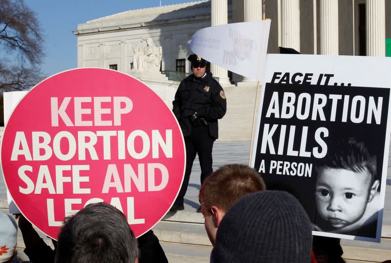 FILE PHOTO: A police officer watches demonstrators on the anniversary of the Supreme Court's 1973 Roe v. Wade abortion decision in Washington