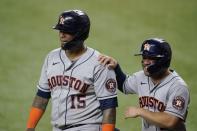 Houston Astros' Martin Maldonado (15) and Jose Altuve, right, celebrate after scoring on an Alex Bregman single in the sixth inning of a baseball game against the Texas Rangers in Arlington, Texas, Thursday, Sept. 16, 2021. (AP Photo/Tony Gutierrez)