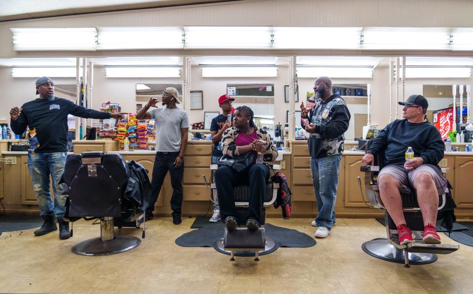 Antonio Patton (left), community activist and organizer of "Barbershop Talks," leads a discussion on gun violence and social media Tuesday, March 15, 2022, inside Mo's Barbershop on the city's east side.