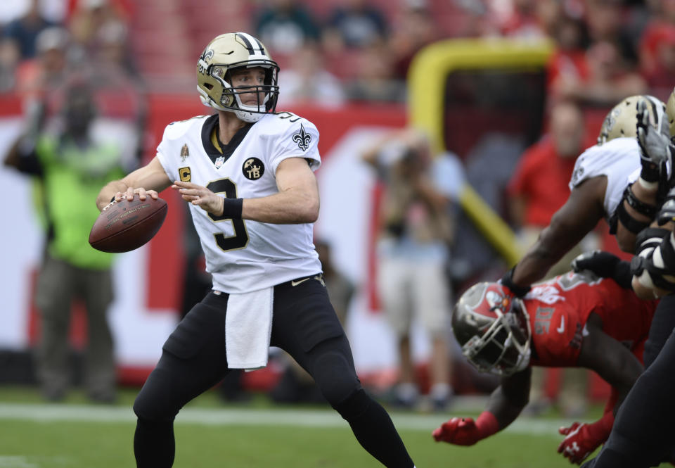 FILE - In this Sunday, Dec. 9, 2018 file photo, New Orleans Saints quarterback Drew Brees (9) throws a pass against the Tampa Bay Buccaneers during the first half of an NFL football game in Tampa, Fla. When Drew Brees became the NFL’s all-time leader in yards passing, he wanted to come up with some sort of gift to thank those who coached him, caught the 6,357 completions it took to set the record, and those who blocked while he threw. His solution was an exhaustive process than involved the production of about 175 unique commemorative footballs and the enlisting Saints front office and public relations staff to help track down 99 receivers, 56 offensive linemen, 11 head or assistant coaches from his 18 pro seasons, as well as a few others Brees saw as instrumental in his success. (AP Photo/Jason Behnken, File)