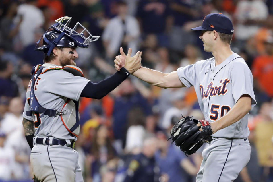 Detroit Tigers catcher Eric Haase, left, and closing pitcher Garrett Hill (50) celebrate after winning in the 11th inning against the Houston Astros in a baseball game Monday, April 3, 2023, in Houston. (AP Photo/Michael Wyke)
