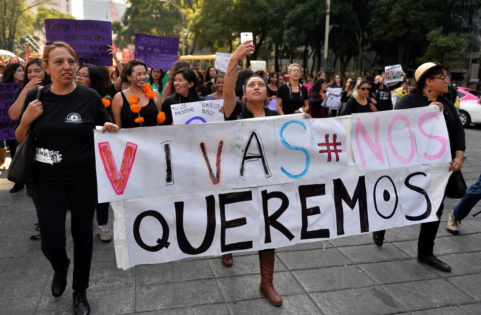 Women march in Mexico City with a poster that says "We want to live."