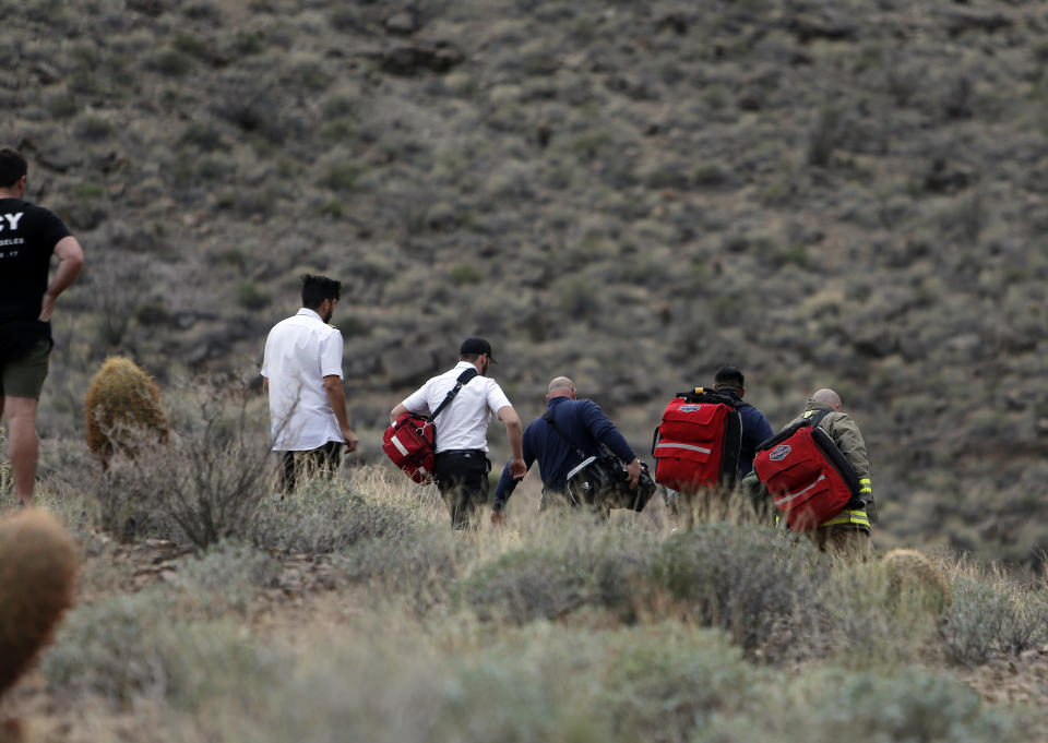 <em>Emergency personnel arrive at the scene after survivors were forced to wait overnight for help to arrive (Teddy Fujimoto/AP)</em>