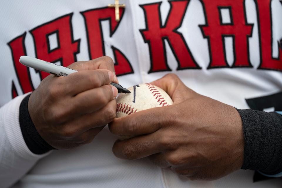 May 9, 2024; Paterson, NJ, USA; NJ Jackals #3 Nilo Rijor autographs a ball before the start of the NJ Jackals home opener at Hinchliffe Stadium.