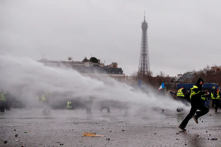 Police use a water cannon during a demonstration by the "yellow vests" movement near the Arc de Triomphe in Paris, France, January 12, 2019. REUTERS/Christian Hartmann