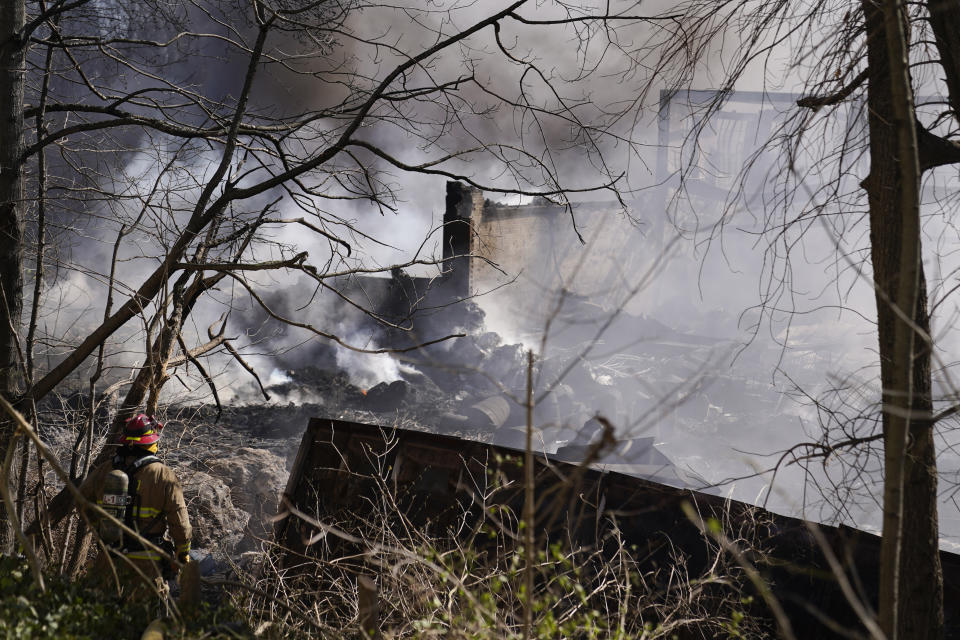 Firefighters continue to pour water on an industrial fire in Richmond, Ind., Wednesday, April 12, 2023. Authorities urged people to evacuate if they live near the fire. The former factory site was used to store plastics and other materials for recycling or resale. (AP Photo/Michael Conroy)