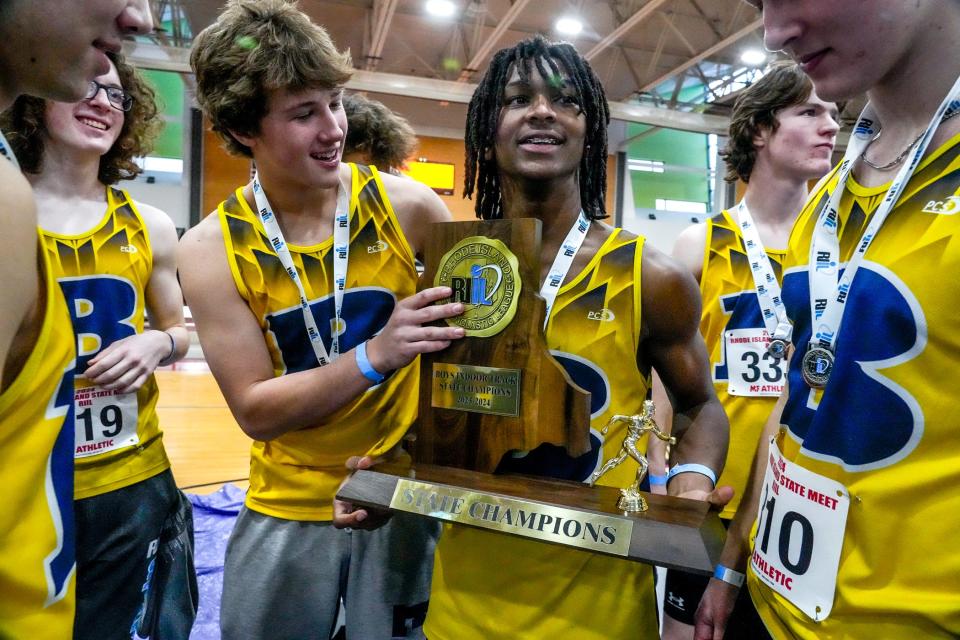 Barrington's Chucky Potter, right, and Ryan Martin hold the team trophy for Boys Indoor Track State Champions