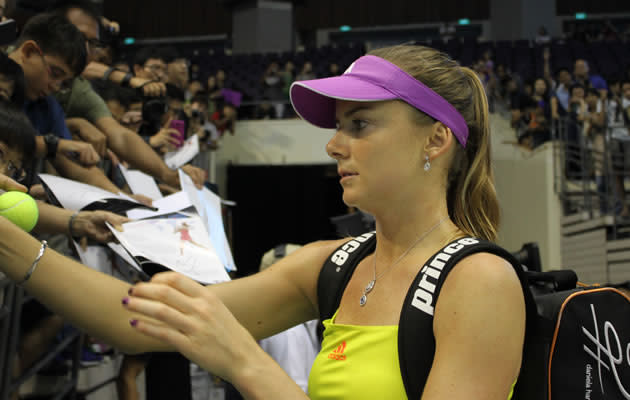 World no. 32 Daniela Hantuchova from Slovakia signs some autographs for her screaming fans after losing the exhibition match to Peng Shuai from China 4-6,3-6. (Yahoo! photo/Melissa Law)