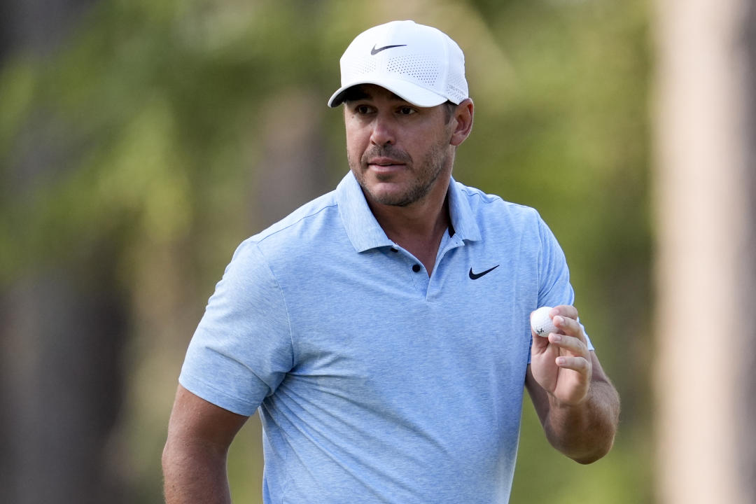 Brooks Koepka waves after making a putt on the second hole during the first round of the U.S. Open golf tournament Thursday, June 13, 2024, in Pinehurst, N.C. (AP Photo/George Walker IV)