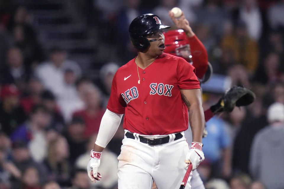 Boston Red Sox's Rafael Devers heads back the dugout after striking out during the sixth inning of a baseball game against the Cincinnati Reds at Fenway Park, Tuesday, May 30, 2023, in Boston. (AP Photo/Charles Krupa)
