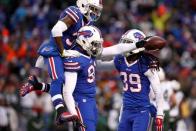 Jan 3, 2016; Orchard Park, NY, USA; Buffalo Bills outside linebacker Manny Lawson (91) celebrates his interception with defensive back Nickell Robey (37) and defensive back Mario Butler (39) during the second half against the New York Jets at Ralph Wilson Stadium. Mandatory Credit: Timothy T. Ludwig-USA TODAY Sports