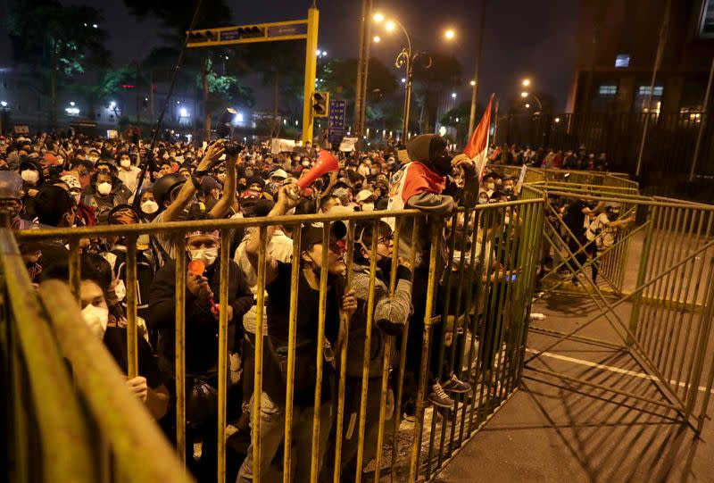 Demonstrators gather behind fences during protests that led to the resignation of Peru's interim President Manuel Merino, in Lima