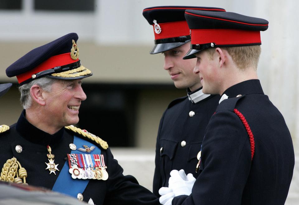 Prince Charles speaks to Prince William and Prince Harry after attending the Sovereign's Parade at the Royal Military Academy in Sandhurst, southern England, April 12, 2006.
