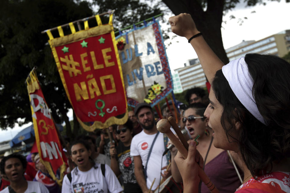 Demonstrators shout slogans during a protest called "Women against Bolsonaro," in Brasilia, Brazil, on Saturday, Oct. 20, 2018. Women and left-wing militants held protests across the country against the right-wing presidential candidate Jair Bolsonaro. (AP Photo/Eraldo Peres)