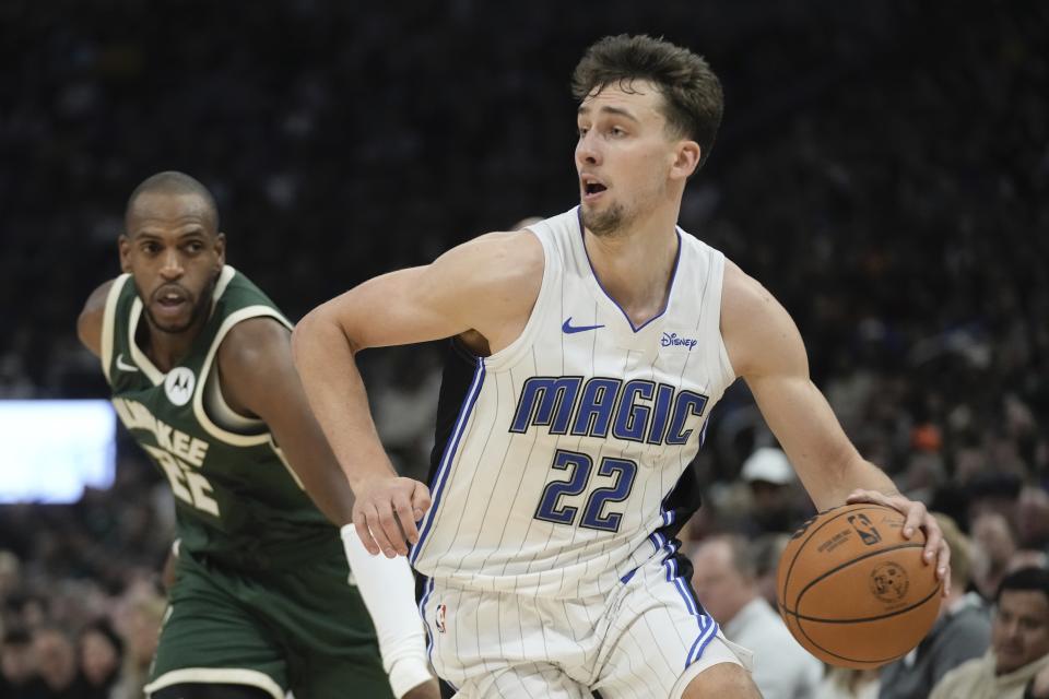 Orlando Magic's Franz Wagner drives past Milwaukee Bucks' Khris Middleton during the first half of an NBA basketball game Thursday, Dec. 21, 2023, in Milwaukee. (AP Photo/Morry Gash)