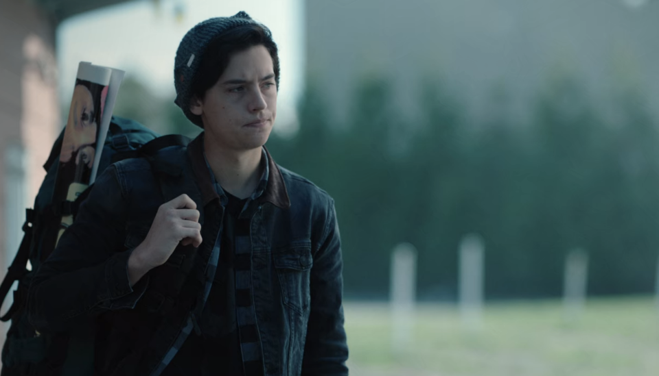 Screenshot from "Riverdale" of a person standing alone and wearing a backpack