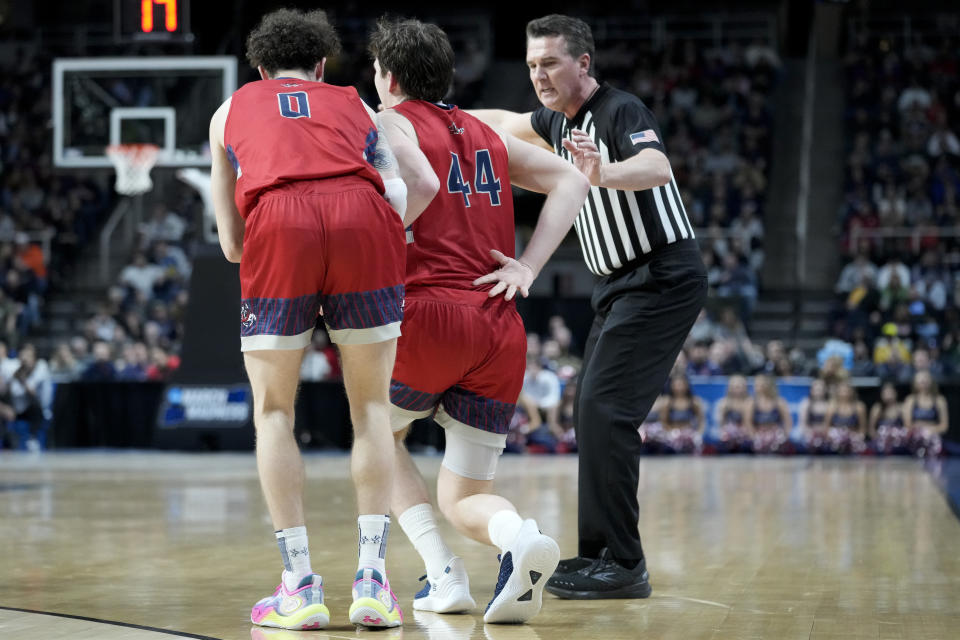 St. Mary's Alex Ducas (44) touches his lower back after an apparent injury in the first half of a second-round college basketball game against Connecticut in the NCAA Tournament, Sunday, March 19, 2023, in Albany, N.Y. (AP Photo/John Minchillo)